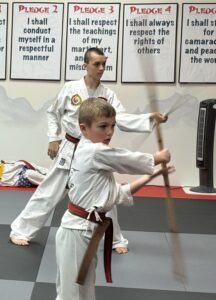 Let's try spinning–Elkhorn students polish their bo staff technique